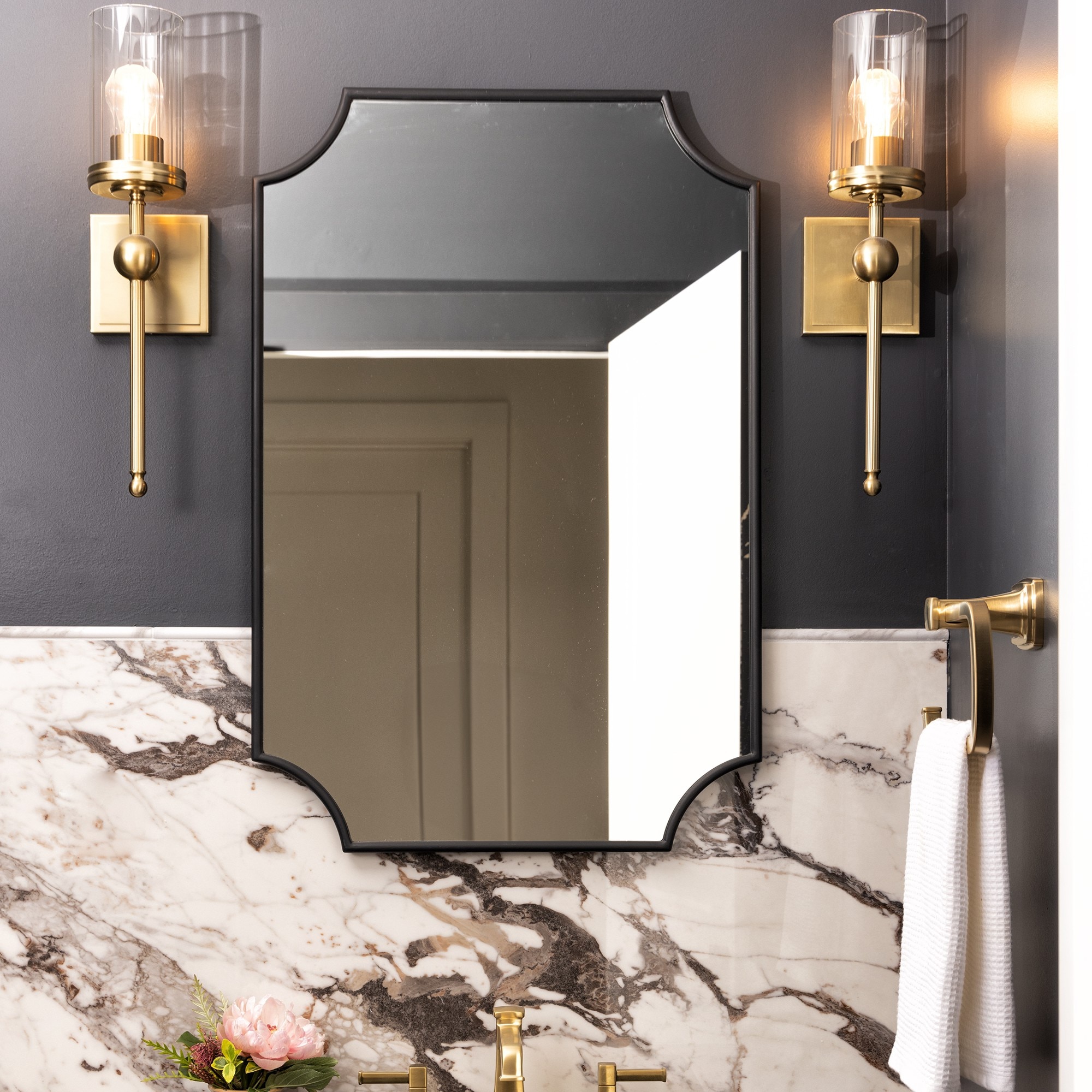 Bathroom vanity with half the wall being black and the other half a white marble slab.