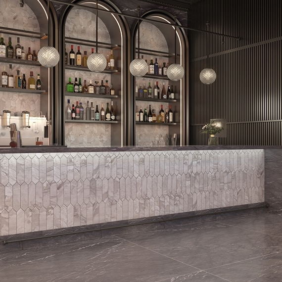 Restaurant bar with backsplash and bar front with picket light gray marble tile, dark gray porcelain slab countertop and floor that look like marble.