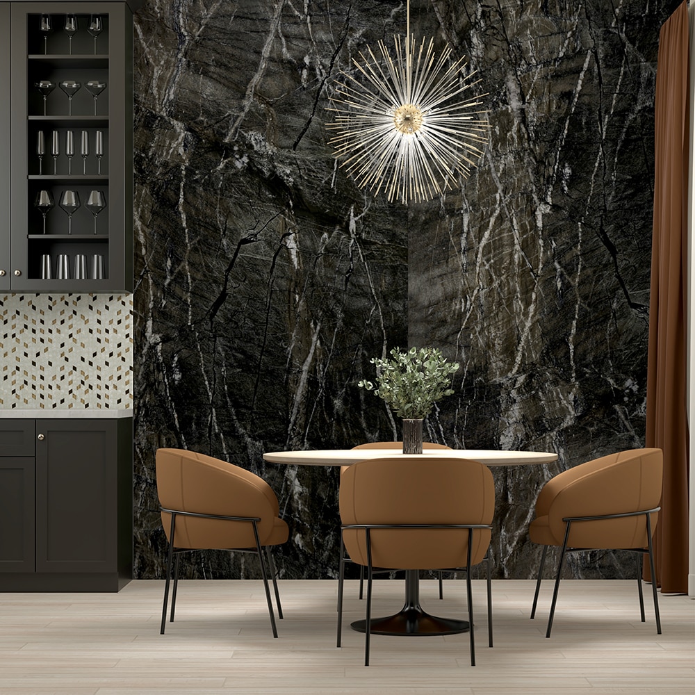 Dining area with a black granite slab on the wall, light wood floor, round table, and light brown sitting chairs.