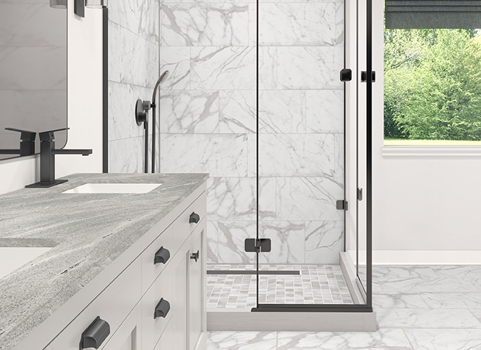 Shower with white granite on shower wall, white mosaic on shower floor, and white granite on bathroom floor.
