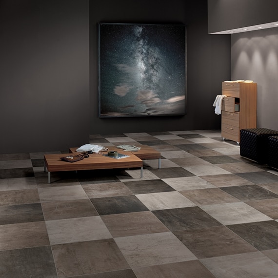 Dressing room with tan, off-white, beige, and brown checkered tiles for flooring, wooden benches, wood chest of drawers, and large painted of the night sky.
