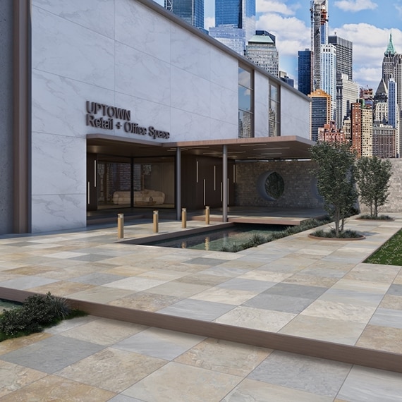 Office building entrance with coy pond, stone-look beige, gray, and cream slip-resistant pavers, wood awning, marble-look porcelain cladding, and view of city skyline.