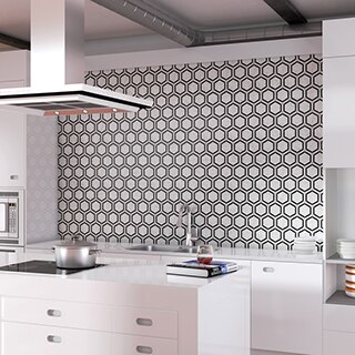 Modern kitchen with black & white hexagon backsplash, white countertop, white cabinets, island with glass stove top & hood vent.