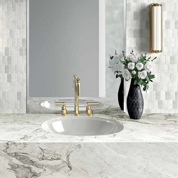 Bathroom with white marble vanity and white marble ingot mosaic backsplash.
