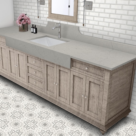 Bathroom with white beveled subway backsplash, gray quartz vanity counter, wood vanity cabinet, and gray & white encaustic floor tile.