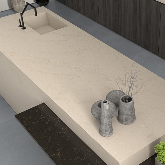 Sideview of kitchen with center island, beige countertops, gray floor, and gray wood cabinets.