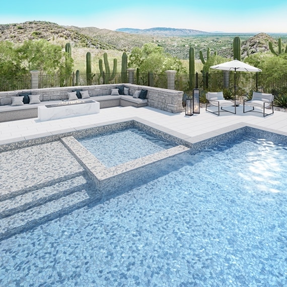 Pool and hot tub with white and gray pebble mosaic pool tile and gray tile border, pool deck with white tile, firepit with marble-look porcelain slab, and outdoor couches.