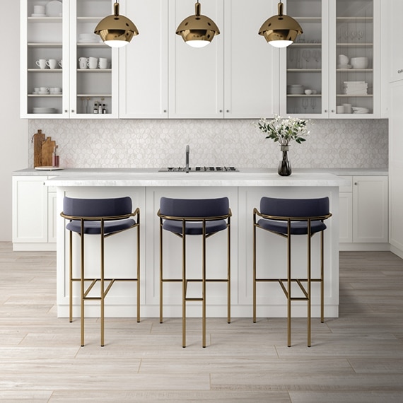 Kitchen with floor tiling that looks like white washed wood, white quartzite countertop, marble look white & beige hexagon tile backsplash, and white cabinets.