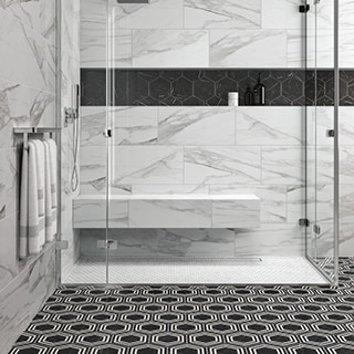 Shower with white penny round shower floor tile, white & gray wall tile that looks like marble, niche with black hexagon tile, and black & white hexagon bathroom floor tile.