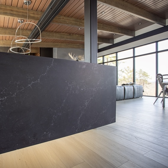 Chip Wade’s residential renovation, Pinhoti Peak, open kitchen / living room with closeup on marble-look black quartz island.