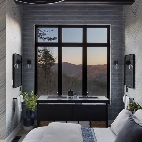 Chip Wade’s residential renovation, Pinhoti Peak, master bedroom with black quartz vanity countertop, gray glossy wall tile, and large windows with mountain view.