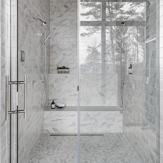 Chip Wade’s residential renovation, Pinhoti Peak, master bathroom shower with white and gray marble look tile and white quartz shower bench and shelving.
