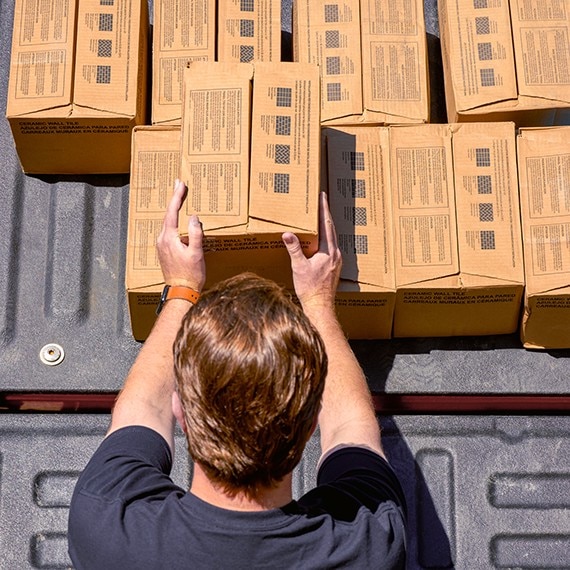 A Daltile Sales Service Center manager loading a customers order into their vehicle.