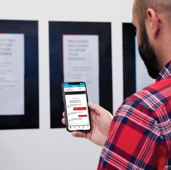 A customer checking the status of their order on their phone with a messaging assistant. 