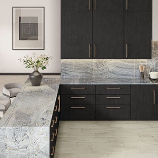 Kitchen with dark wood cabinets, brass drawer pulls, gray natural quartzite countertop and backsplash, floor tile that look like blonde wood planks.