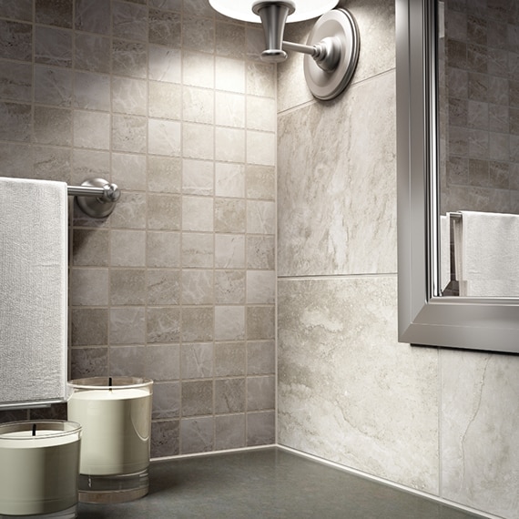 Closeup of travertine look tile in 2x2 ceramic mosaic and coordinating 10x14 ceramic tile.