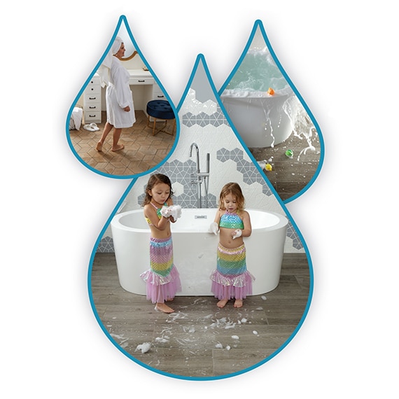 Water droplets with two girls in mermaid costumes playing in a bathroom with wood-look slip-resistance flooring.