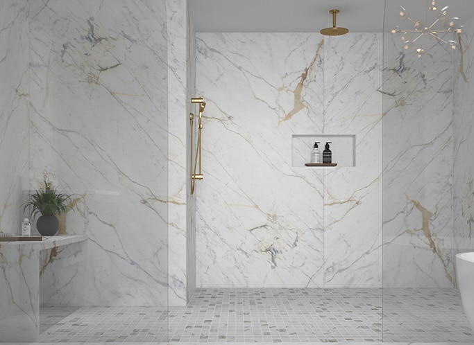 Shower with white marble on the walls and floor, and white mosaic on the shower floor.