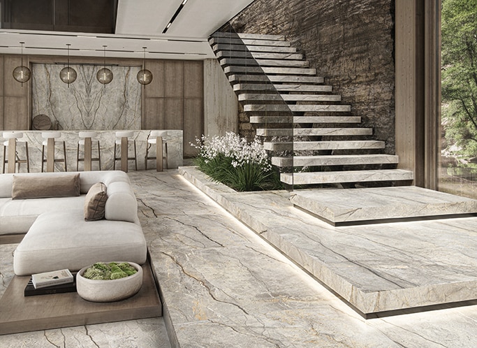 High end living room with bar, white couch and bar chairs, stairs, and white marble flooring on stairs and floor, white marble on bar counter and backsplash.
