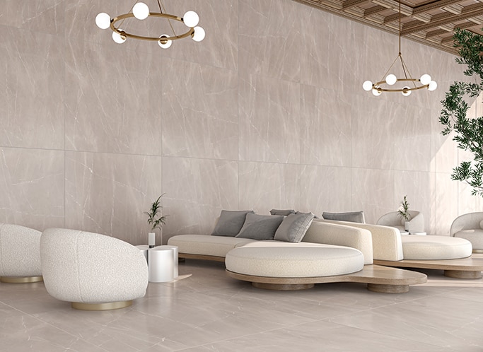High end lounge area with white couches and chairs, wood ceiling, and beige marble look slab on walls and floor.