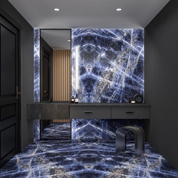 Bathroom featuring wall and flooring of large formal porcelain slab with dark blue and white veining that looks like marble, floor-to-ceiling mirror, and dark grey floating vanity.