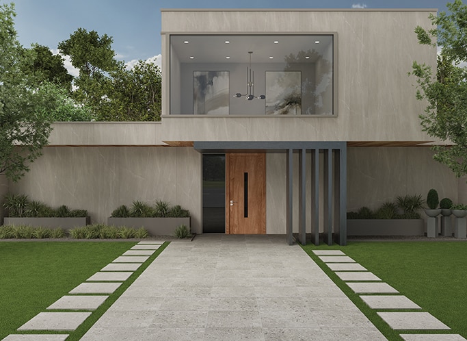 Modern house with gray slab on walls, gray pavers leading up to front door, and plants on the porch.