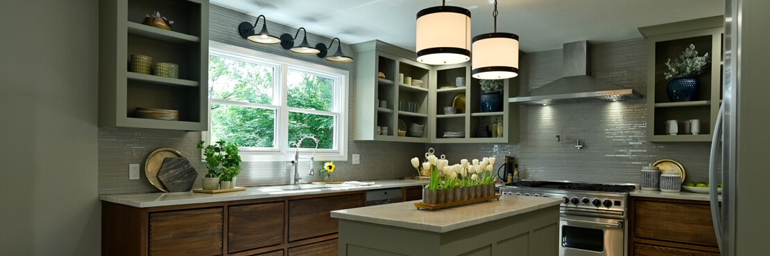 Modern farmhouse kitchen with taupe natural quartzite countertop & island, taupe glass mosaic backsplash, open upper cabinets, and wood lower cabinets.