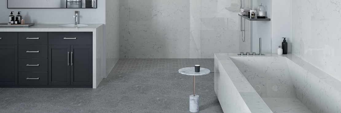 Modern bathroom design with white with gray veining quartz slab vanity countertop, shower walls, bathtub, and backsplash, and gray concrete look floor tile.