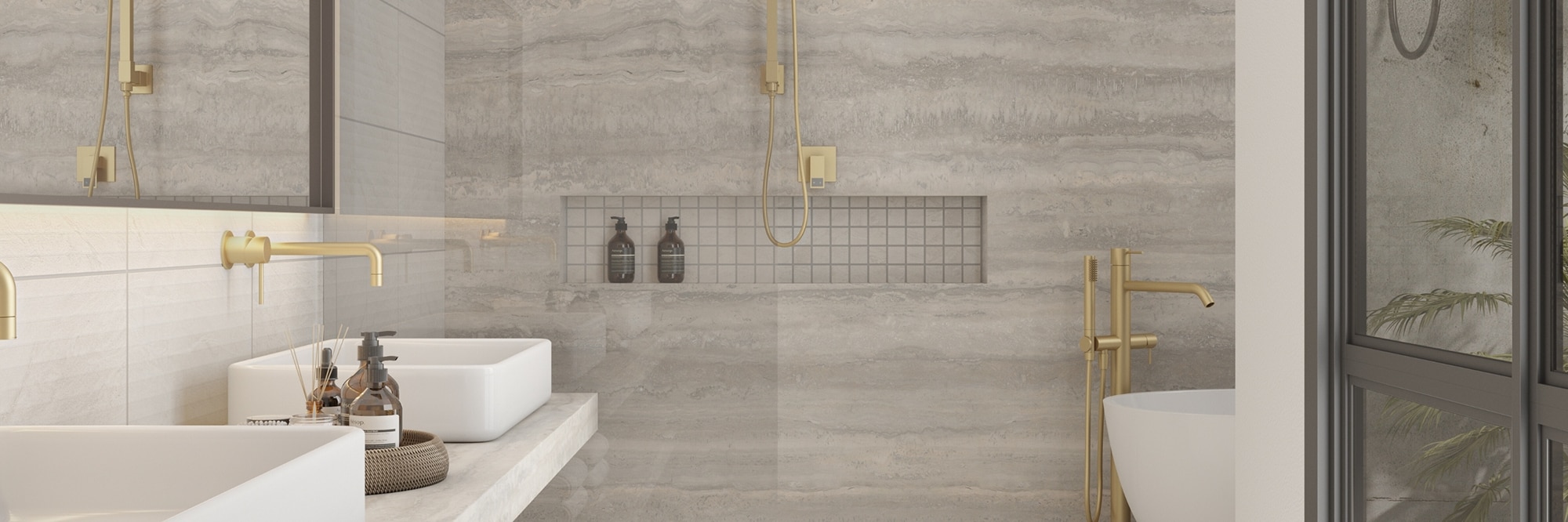 Open shower with soaker tub, floating vanity and shower walls of gray porcelain slab that looks like travertine, mosaic shower floor & shower niche, and brass fixtures.