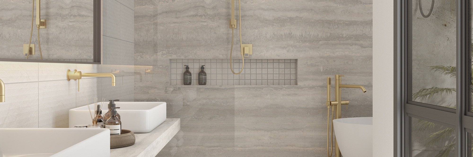 Open shower with soaker tub, floating vanity and shower walls of gray porcelain slab that looks like travertine, mosaic shower floor & shower niche, and brass fixtures.