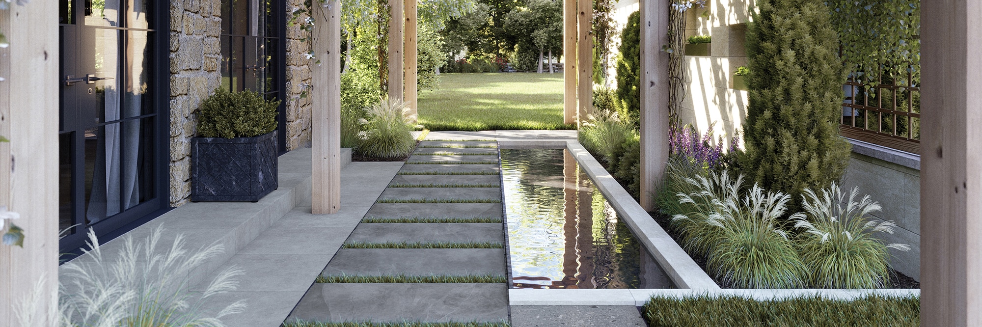 Close up of residential outdoor courtyard walkway of porcelain paver tiles set in grass, next to a coy pond.
