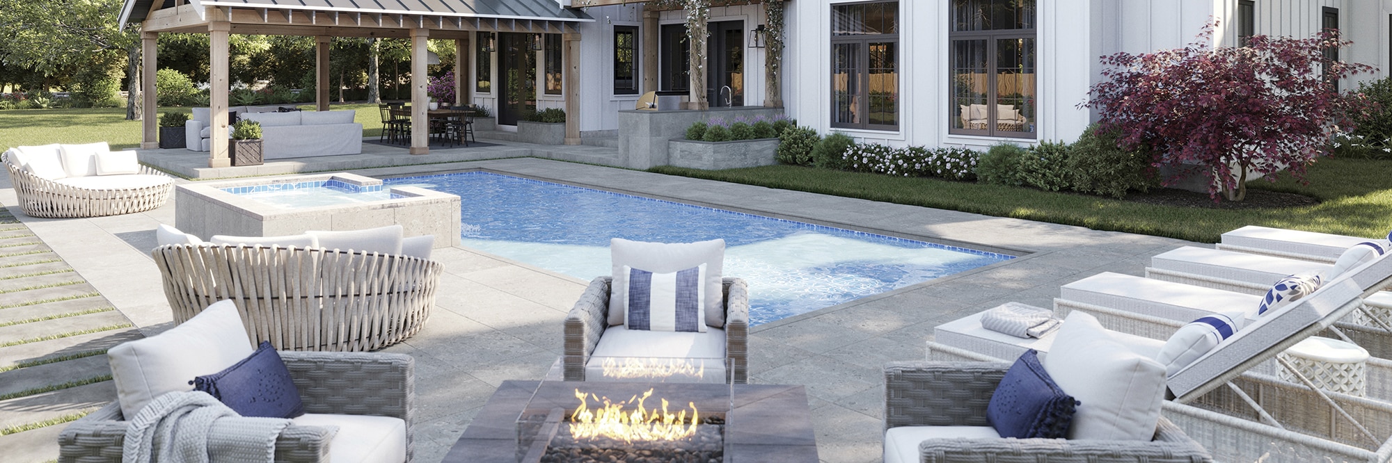 Modern farmhouse two-story home with white wood siding, pool with blue tile & gray deck that looks like stone, covered patio with couch and dining table.