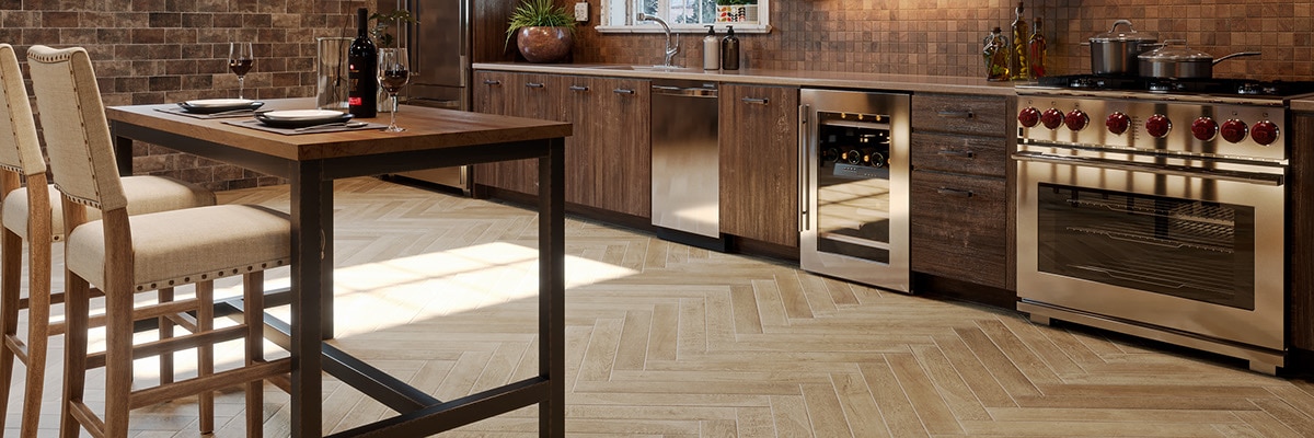 Urban loft kitchen with brick walls, herringbone tile flooring that looks like wood, commercial grade stainless steel gas stove/oven, and wine refrigerator.