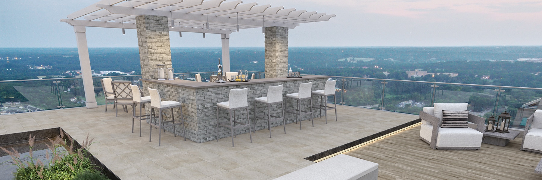 Rooftop patio with a city view, gray stacked stone bar, seating area with white couch, chairs, gray coffee & side tables, and wood look slip-resistant floor tile.