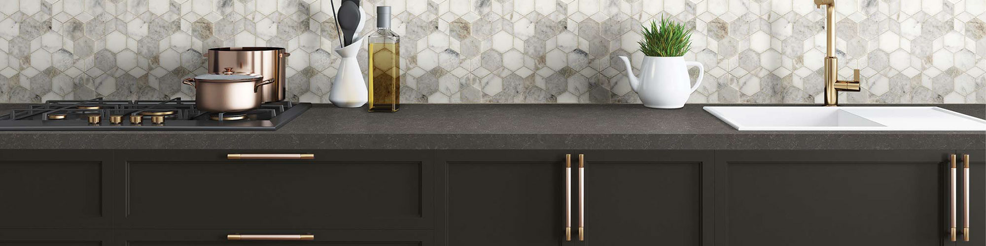 Kitchen white & gray marble mosaic backsplash with black & brass gas stove, dark brown quartz countertop and cabinets.