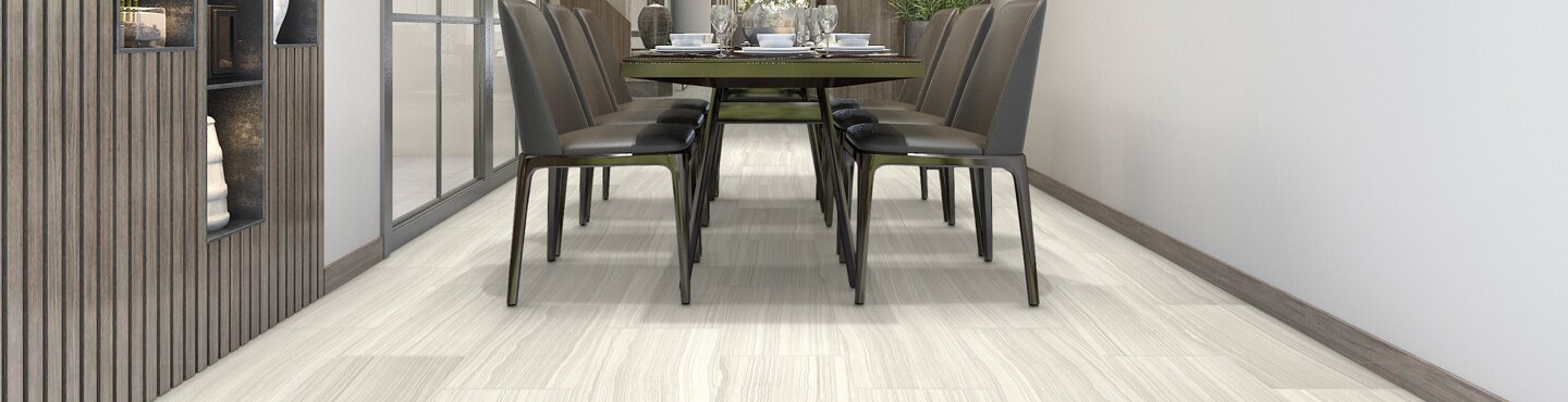 Dining room with beige stone look tile flooring, built-in cabinet with wood slat front & white vases, brown table with 6 chairs.