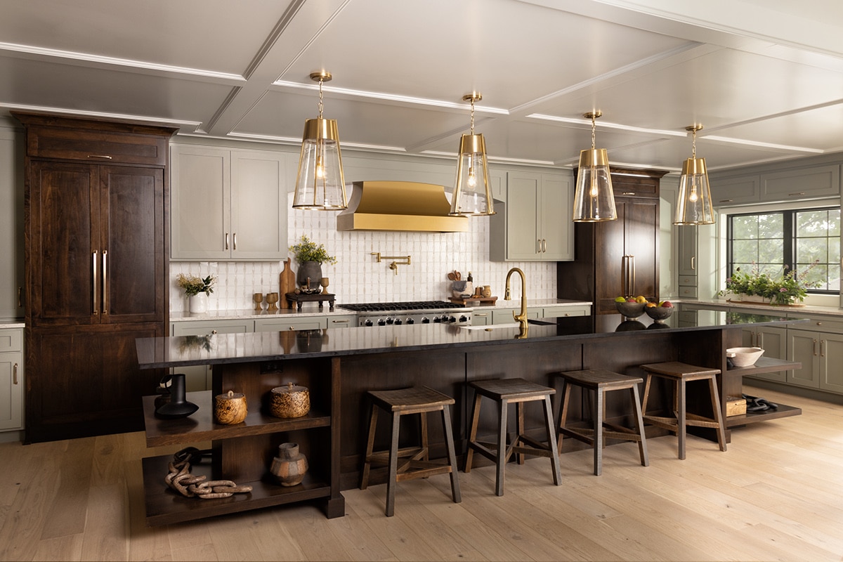 Kitchen with dark wood cabinets, black marble countertop on the island and perimeter countertops, and a white mosaic on the backsplash. 