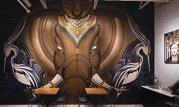 Coffee shop with mural of brown elephant.
