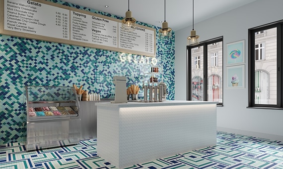Ice cream parlor with light blue, navy, and teal arabesque mosaic wall tile, white, navy, teal, mint, and light blue mosaic floor tile, and white mosaic checkout counter.
