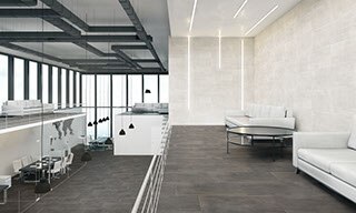 Corporate office with gray concrete tile flooring, off-white concrete wall tile, black conference tables & white chairs, and floor-to-ceiling windows.