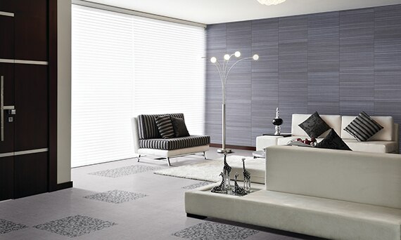 Modern living room with blue fabric look wall tile, arched floor lamp, white sofas, floor-to-ceiling windows, and gray fabric look floor tile.
