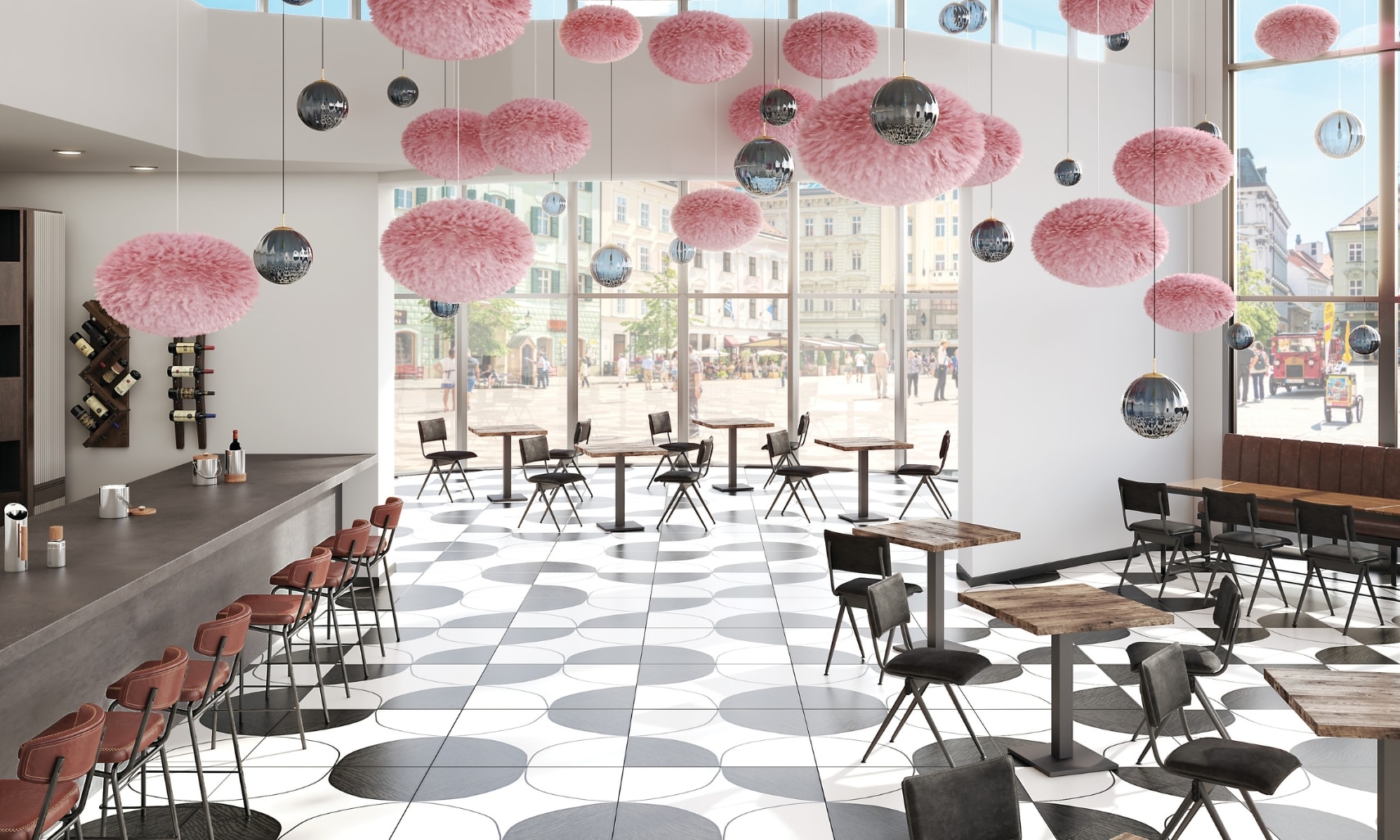 Restaurant with white floor tile with black circles & designs, pink & silver décor hanging from the ceiling, wood tables with black chairs, gray porcelain slab countertop.