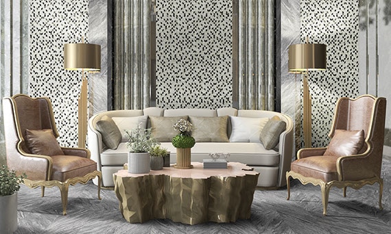 Ornate lobby with gray marble look floor tile in a herringbone pattern, black & gray mosaic wall tile with marble look tile columns, ivory sofa, tan leather side chairs, and tree trunk coffee table.
