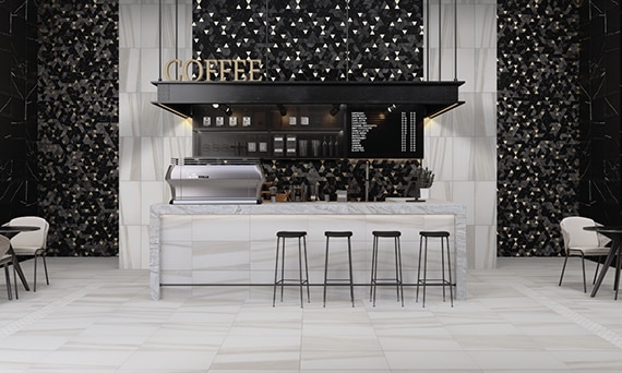 Coffee shop with 12x24, white & beige marble floor tile, black mosaic wall tile, marble countertop, hanging sign with menu.