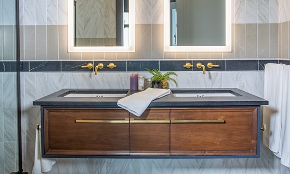 Chip Wade’s residential renovation, Pinhoti Peak, ADU bathroom with black quartz countertop, backsplash of white marble look tile, black marble look tile, and gray wall tile.