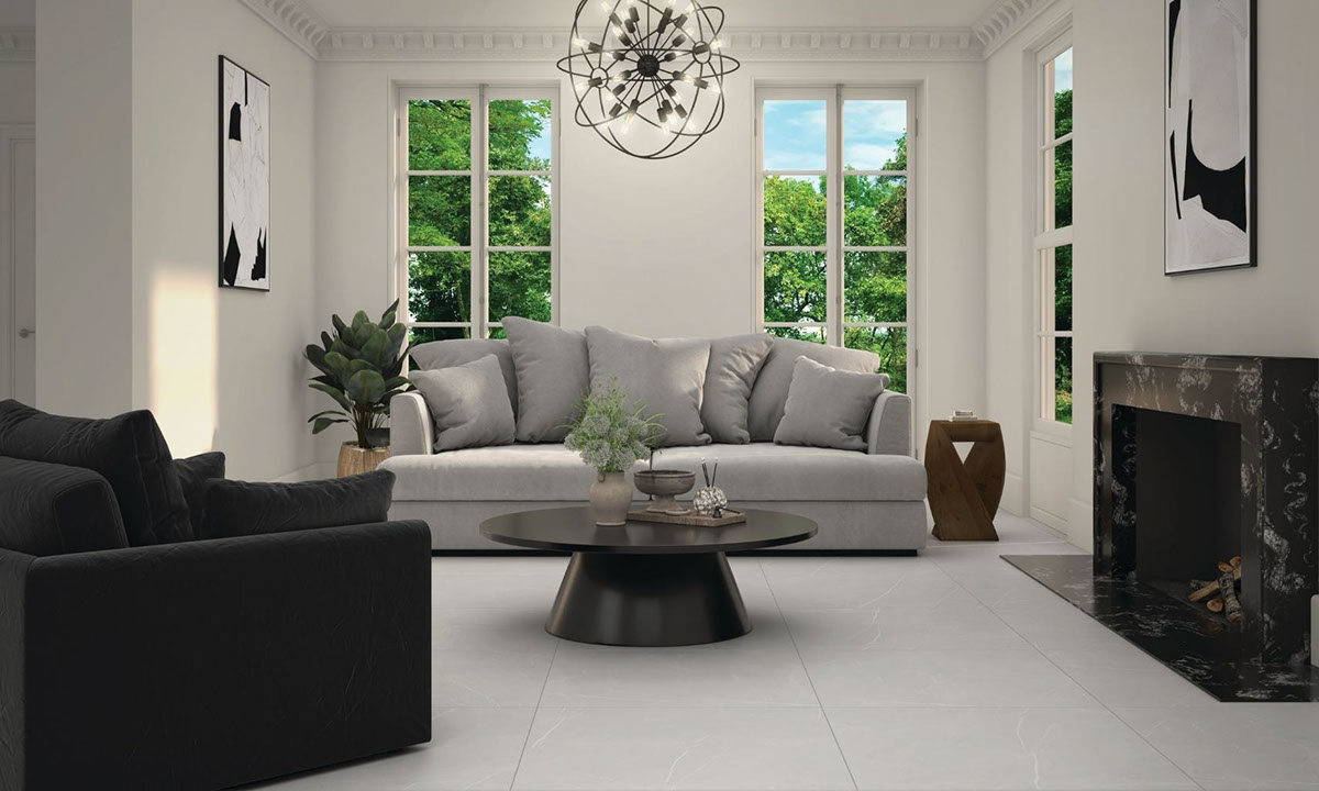 Living room with light gray tile floor that looks like marble, black & white granite fireplace, light gray velvet over-stuff sofa, and black velvet chair.