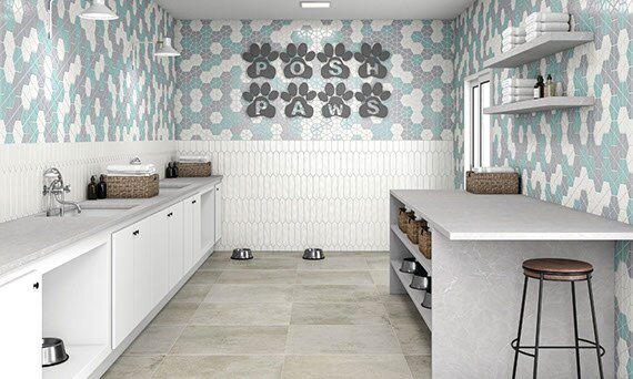 Veterinarian’s dog grooming room with teal, gray & white mosaic wall tile, white picket tile wainscot, gray quartz countertops with sinks and white rolled towels.