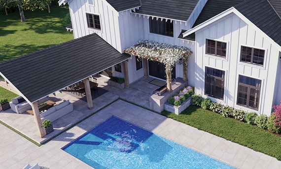 Bird’s eye view of modern farmhouse backyard with covered patio, pool, and flower-covered pergola with gray stone look tile flooring.