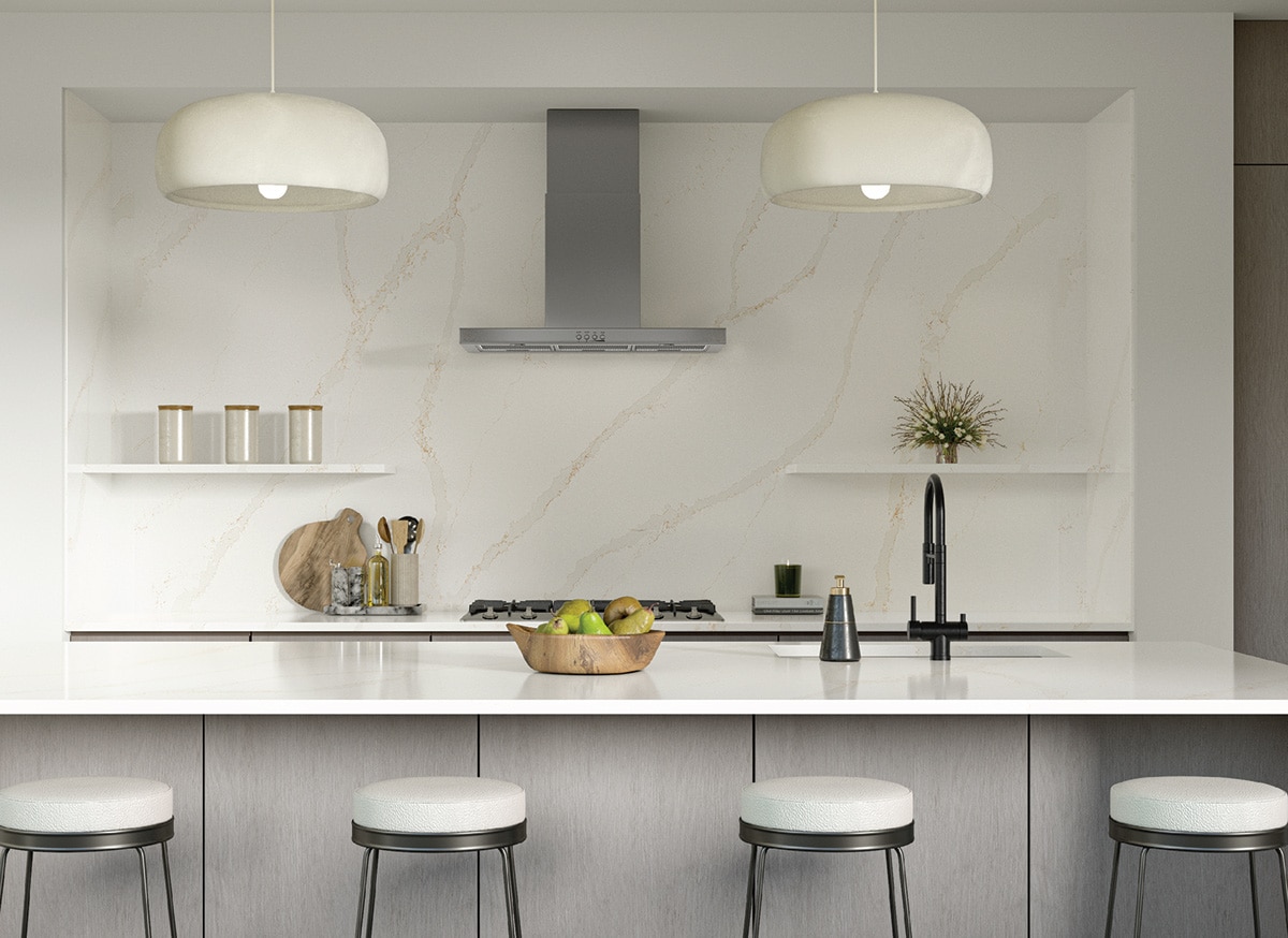 Kitchen with white marble slab backsplash, center island with a white marble countertop, and white sitting stools.