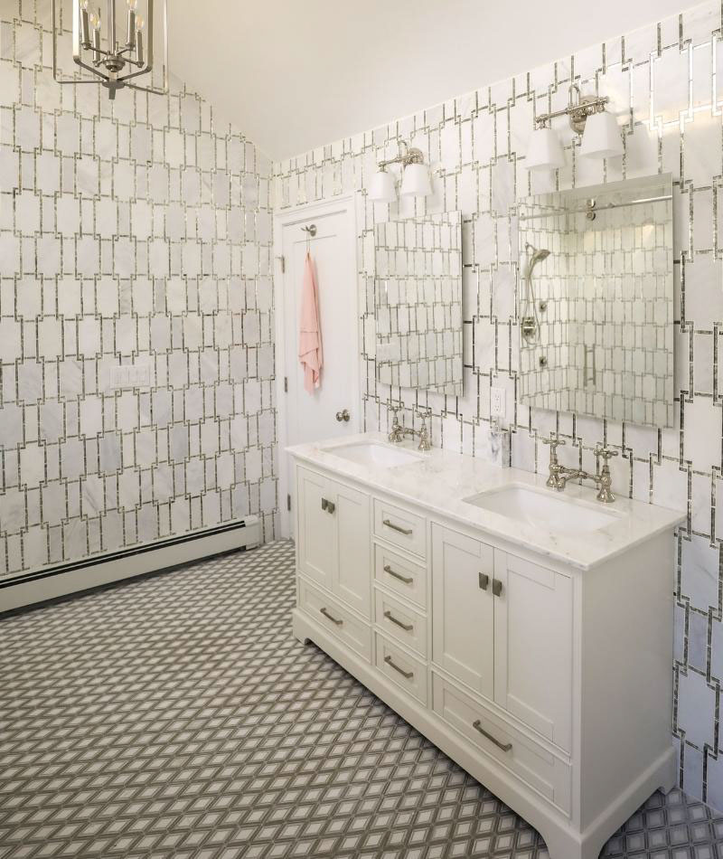 Bathroom with white marble & antique mirror wall tile, white marble vanity countertop & white cabinets, white & gray diamond-shaped mosaic floor tile.
